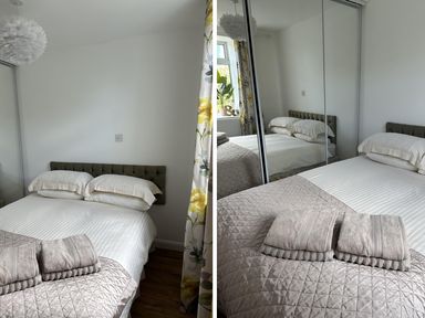 A bedroom with a bed and pillows at Dog-friendly lodge, steps to St Ives train Hayle