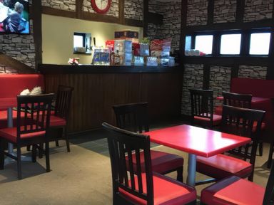 A dining area with tables and chairs at a Pet-friendly lodge with hot tub near the coast