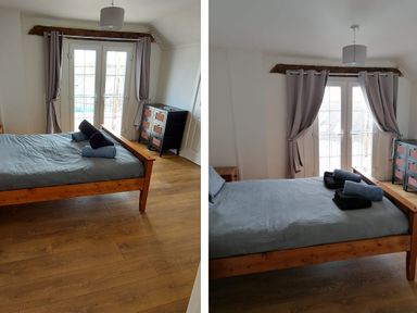 A bedroom with a bed and sliding doors at Surf-ready apartment with sea views in town