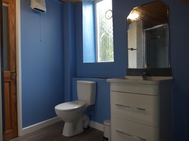 A bathroom with sink and toilet at Surf-ready apartment with sea views in town