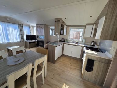 A kitchen with appliances and seating area at Beach holiday base with pool and kids' activities