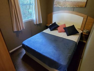 A bedroom with a bed and pillows at tbc in 