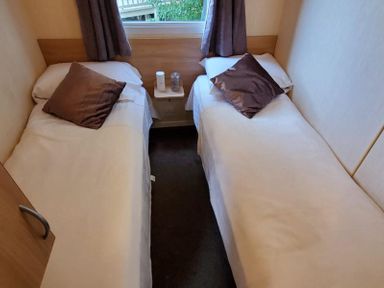 A bedroom with two beds and a window at tbc in 