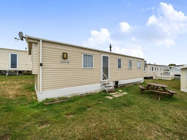 A mobile home exterior with a picnic table at Pet-friendly lodge near Fistral Beach, Fistral Beach, Newquay