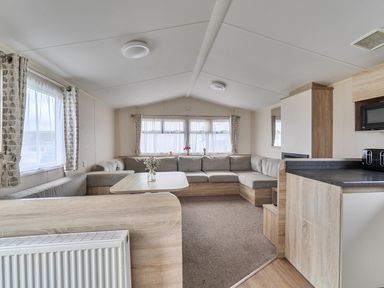 A living room with a sofa and table at Pet-friendly lodge near Fistral Beach, Fistral Beach, Newquay