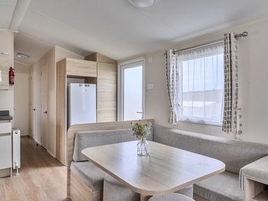 A kitchen with a table and sofa at Pet-friendly lodge near Fistral Beach, Newquay
