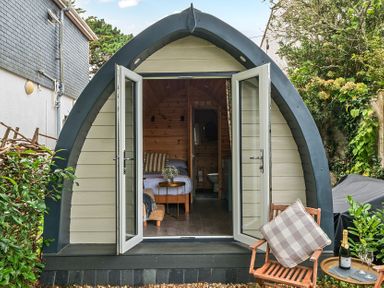 A pod with a bed and seating area at Peaceful pod with bay views, walk to 3 beaches St Ives
