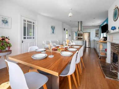A dining room with a table set for a meal at tbc in 