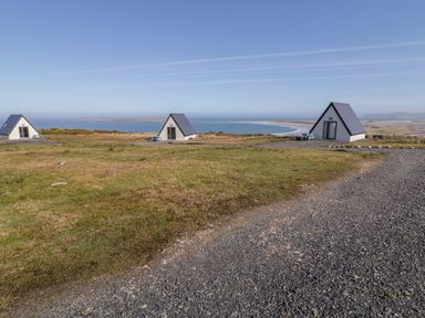 Three houses with a view of the ocean at Cabin 9 Inish Beag, Gortahawk