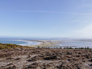 A view of a beach and ocean from a hillside at Cabin 9 Inish Beag in Gortahawk