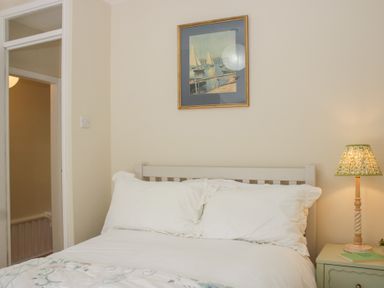 A bedroom with a bed and a bedside table at Upper Frogpool Cottage in Crediton
