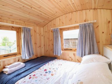 A bedroom with a bed and windows at Hazel in 