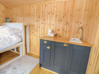 A bedroom with a loft bed and a sink unit at Hazel
