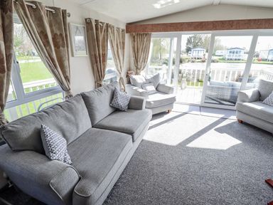A living room with sofas and armchairs at 13 The Lakes in Mablethorpe