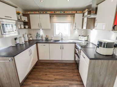 A kitchen with appliances and utensils at 13 The Lakes in Mablethorpe