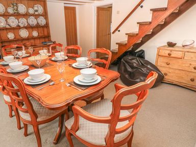 A dining room with a table set for dinner at Maerdy Lodge