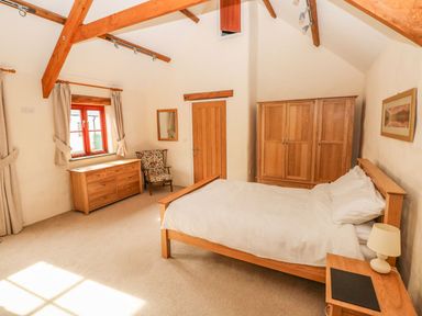 A bedroom with a bed and furniture at Maerdy Lodge