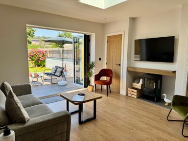 A living room with a sofa and a coffee table at Y Bwthyn in Pembrey