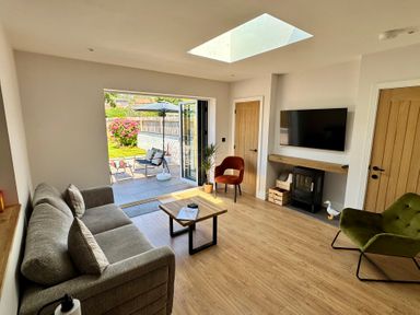 A living room with seating and a coffee table at Y Bwthyn in Pembrey