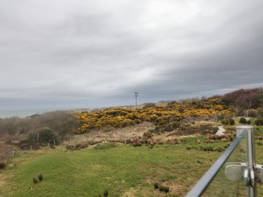 View of bushes and sea under cloudy sky at 2 Ard an Chuain Dunfanaghy