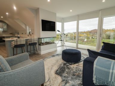 A living room with a television and telescope at 2 Ard an Chuain in Dunfanaghy