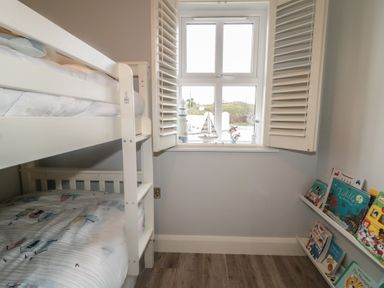 A bedroom with a bunk bed and bookshelf at 2 Ard an Chuain Dunfanaghy