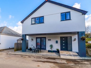 A house with front door and seating area at Meadow Retreat in Bodmin