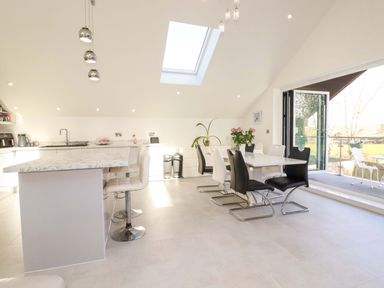 A kitchen with a dining table and sliding door at Meadow Retreat in Bodmin