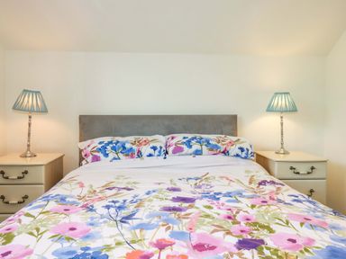 A bedroom with a bed and bedside tables at Meadow Retreat in Bodmin