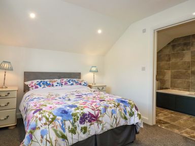 A bedroom with a bed and lamps at Meadow Retreat in Bodmin