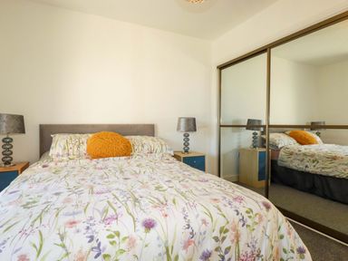 A bedroom with a bed and bedside tables at Meadow Retreat in Bodmin