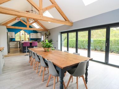 A kitchen with a large dining table and chairs at Hazeldene near Harvington