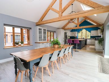 A kitchen with a dining table and chairs at Hazeldene near Harvington