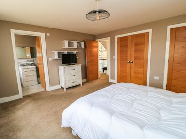 A bedroom with a bed and television at Hazeldene near Harvington