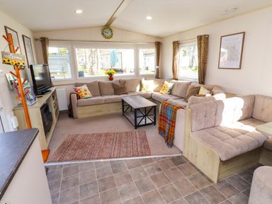 A living room with a sofa and coffee table at Sunflower Retreat, Caravan 61