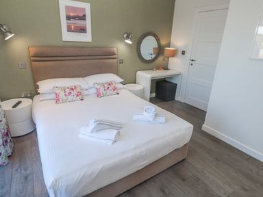 A bedroom with a bed and bedside tables at Warleggan in Redruth