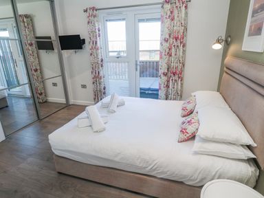 A bedroom with a bed and a TV at Warleggan in Redruth
