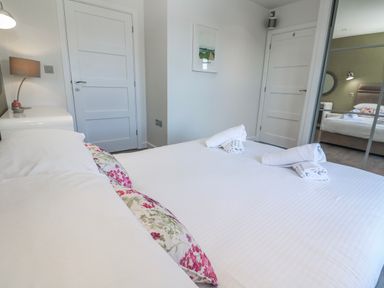 A bedroom with a bed and lamp at Warleggan in Redruth