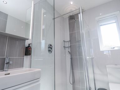 A bathroom with a shower and sink at Warleggan in Redruth