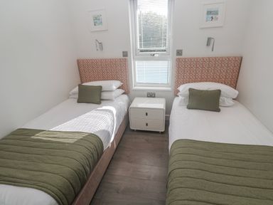 A bedroom with two beds and a nightstand at Warleggan in Redruth