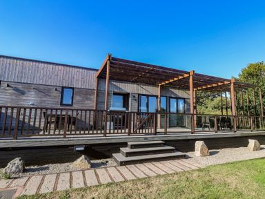 An outdoor area with a deck and pergola at Warleggan in Portreath