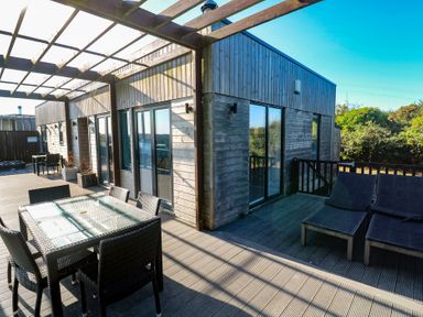 An outdoor space with a table and chairs at Warleggan in Portreath
