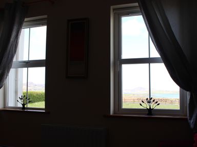 Windows with decorative plants and curtains at Welcome to the wild Atlantic way Mulroy Bay