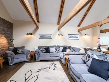 A living room with sofas and a coffee table at Cider Press Cottage in Torpoint