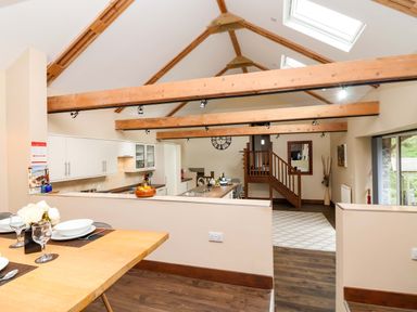 A kitchen with a dining table and counter at Cider Press Cottage Torpoint