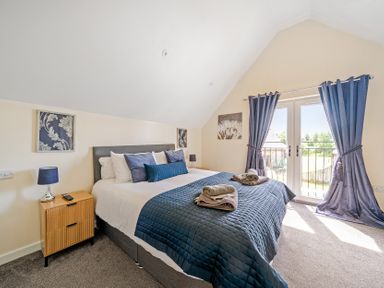 A bedroom with a bed and bedside table at Lodge 4 Near Brigg