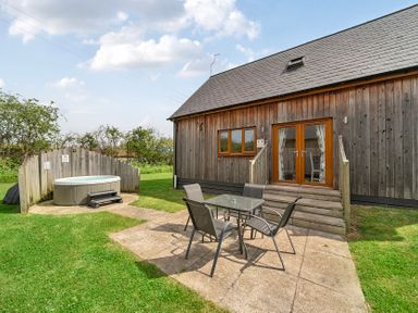 An outdoor area with a hot tub and a seating arrangement at Lodge 4 Near Brigg