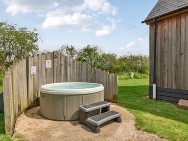 An outdoor area with a hot tub and stool at Lodge 4 Near Brigg