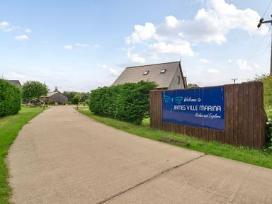 A driveway leading to a sign at James Ville Marina near Brigg