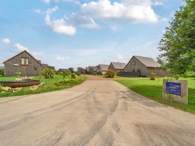 An outdoor area with lodges and a sign at Lodge 4 near Brigg